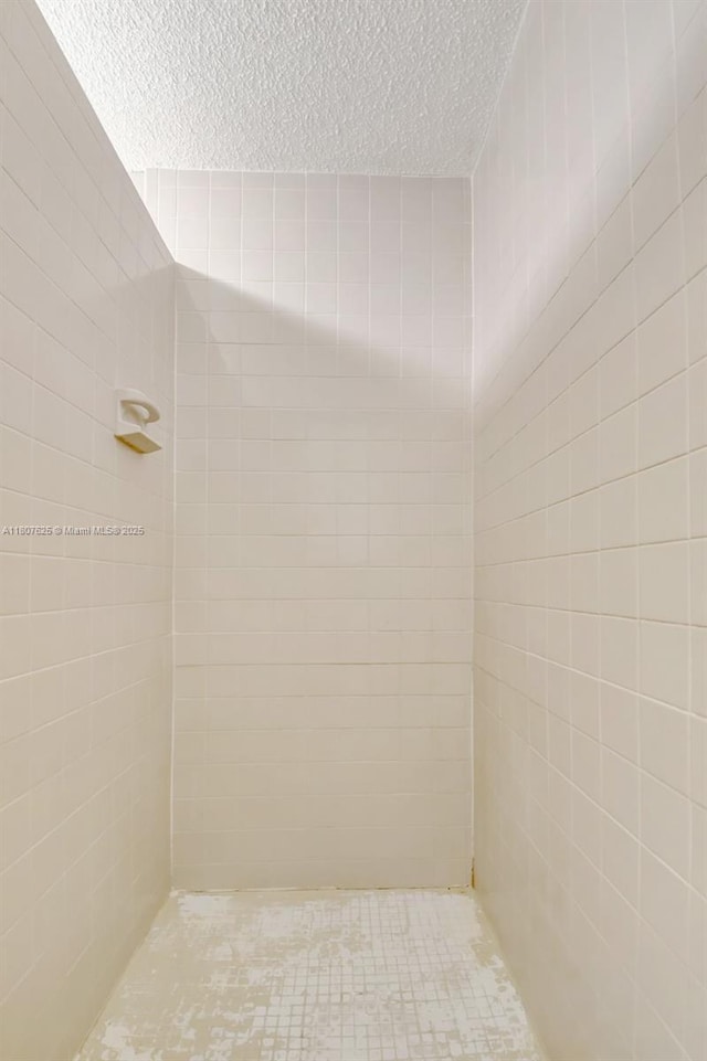 6160 Camp Lee Rd, West Palm Beach, FL 33417 - full bath featuring a textured ceiling and a tile shower