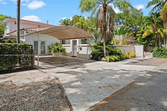 1771 Wa Kee Na Dr, Miami, FL 33133 - rear view of house featuring a tiled roof, a gate, and a fenced front yard