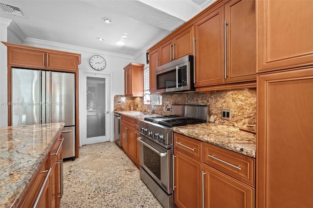 1771 Wa Kee Na Dr, Miami, FL 33133 - kitchen with stainless steel appliances, a sink, ornamental molding, light stone countertops, and brown cabinetry
