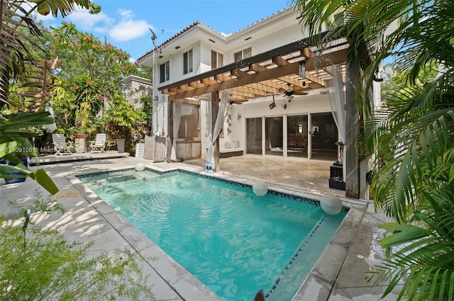 1771 Wa Kee Na Dr, Miami, FL 33133 - back of house featuring a pergola, a patio, a ceiling fan, an outdoor pool, and stucco siding