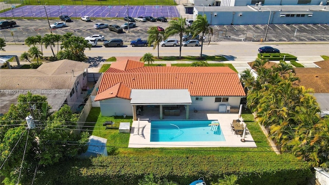 8930 SW 50th Ter, Miami, FL 33165 - back of house featuring a tiled roof, a patio, and a community pool