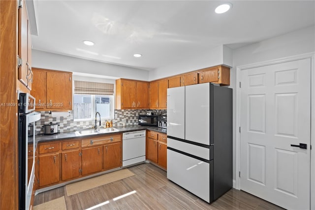 8930 SW 50th Ter, Miami, FL 33165 - kitchen featuring white appliances, a sink, brown cabinets, and recessed lighting