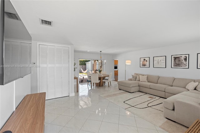 8930 SW 50th Ter, Miami, FL 33165 - living room with light tile patterned floors and a chandelier