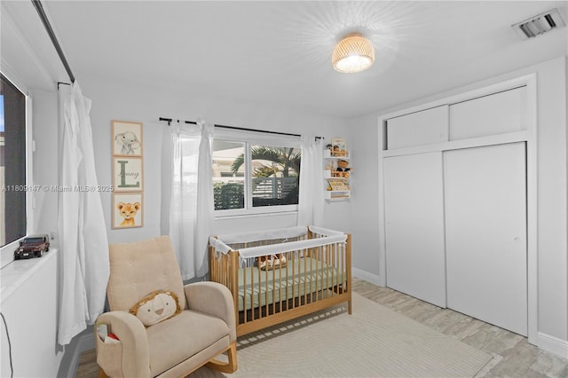8930 SW 50th Ter, Miami, FL 33165 - bedroom featuring a nursery area, baseboards, a closet, and wood finished floors
