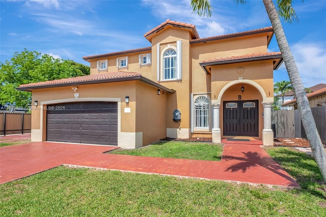 5972 SW 163rd Pl, Miami, FL 33193 - mediterranean / spanish home featuring stucco siding, an attached garage, decorative driveway, and a tiled roof