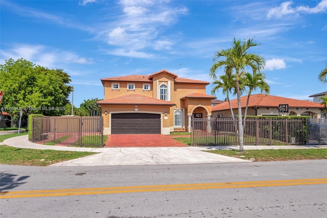 5972 SW 163rd Pl, Miami, FL 33193 - mediterranean / spanish-style house featuring stucco siding, a tiled roof, driveway, an attached garage, and a gate