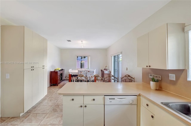 5972 SW 163rd Pl, Miami, FL 33193 - kitchen featuring white dishwasher, a peninsula, cream cabinets, light countertops, and a sink