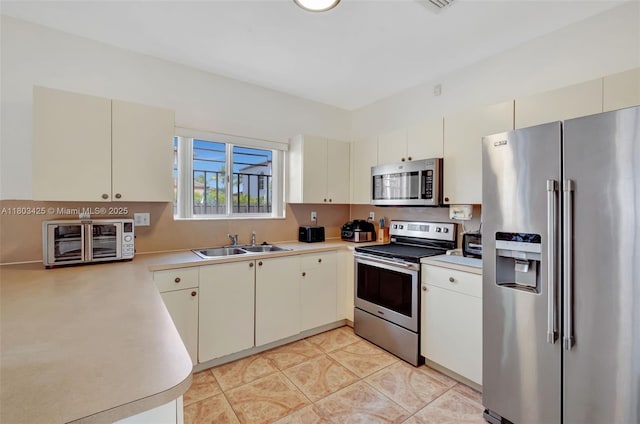 5972 SW 163rd Pl, Miami, FL 33193 - kitchen with appliances with stainless steel finishes, light countertops, and light tile patterned floors