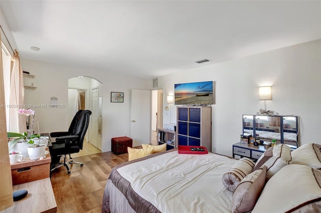 5972 SW 163rd Pl, Miami, FL 33193 - bedroom with arched walkways, wood finished floors, and a desk