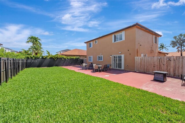 5972 SW 163rd Pl, Miami, FL 33193 - back of property featuring stucco siding, a fenced backyard, and a patio