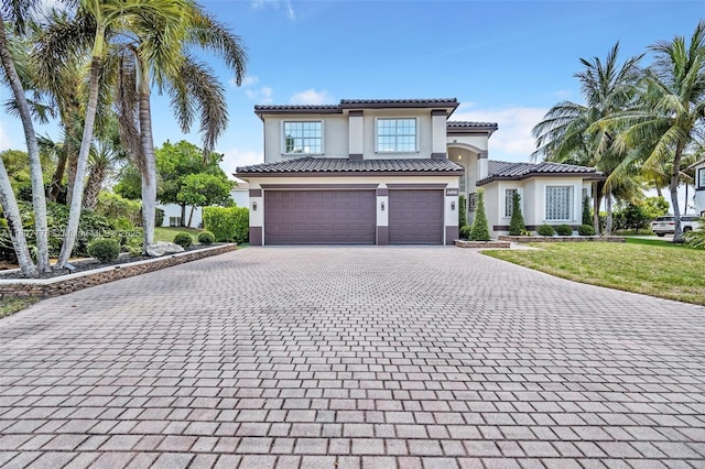 5466 SW 187th Ter, Miramar, FL 33029 - mediterranean / spanish-style home featuring decorative driveway, stucco siding, an attached garage, a front yard, and a tiled roof