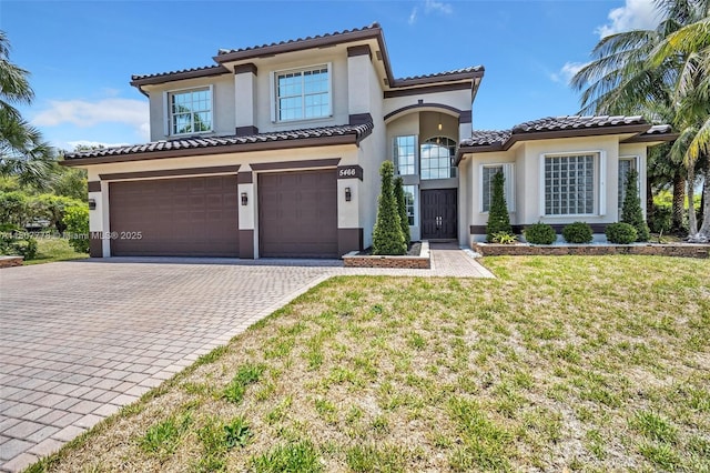 5466 SW 187th Ter, Miramar, FL 33029 - mediterranean / spanish home featuring a garage, stucco siding, driveway, and a tile roof