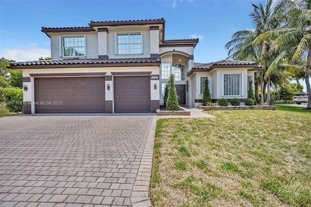 5466 SW 187th Ter, Miramar, FL 33029 - mediterranean / spanish-style house featuring stucco siding, decorative driveway, a garage, a front lawn, and a tile roof