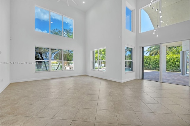 5466 SW 187th Ter, Miramar, FL 33029 - unfurnished room featuring tile patterned flooring, a towering ceiling, and baseboards