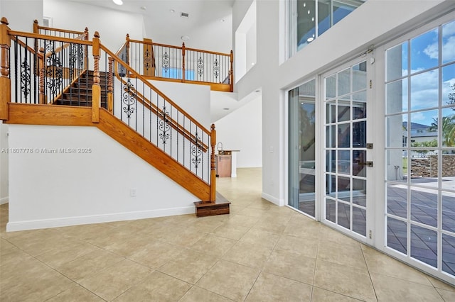 5466 SW 187th Ter, Miramar, FL 33029 - stairway featuring tile patterned flooring, baseboards, a towering ceiling, and recessed lighting