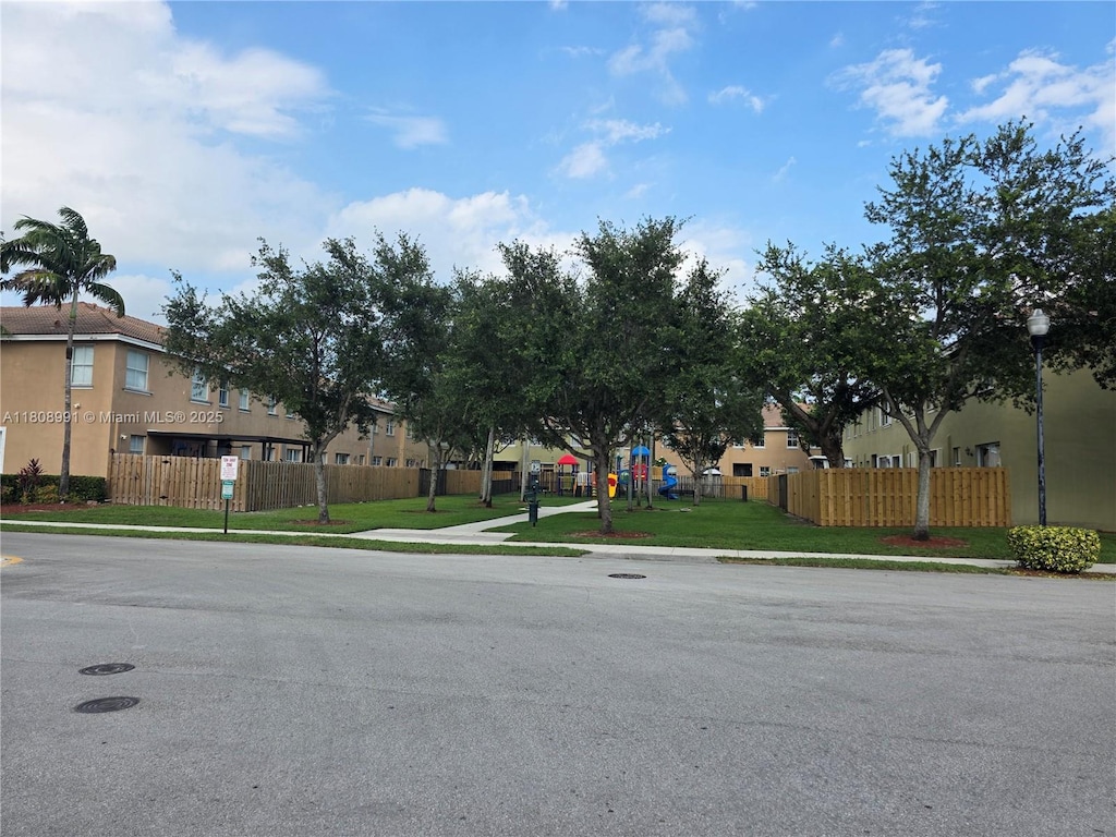 1435 SE 24th Ave, Homestead, FL 33035 - view of asphalt street with sidewalks, street lighting, a residential view, and curbs