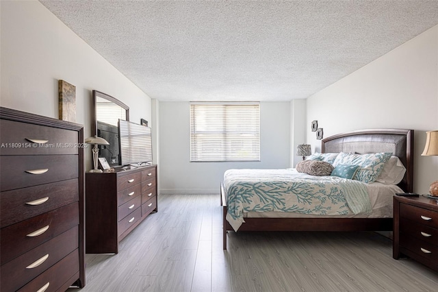 2000 S Ocean Blvd Unit 3B, Lauderdale By The Sea, FL 33062 - bedroom with light wood-type flooring, a textured ceiling, and baseboards