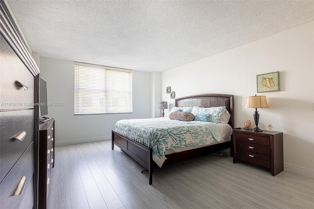 2000 S Ocean Blvd Unit 3B, Lauderdale By The Sea, FL 33062 - bedroom with baseboards, a textured ceiling, and light wood finished floors