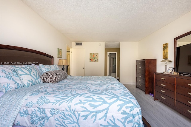 2000 S Ocean Blvd Unit 3B, Lauderdale By The Sea, FL 33062 - bedroom featuring light wood-style flooring and a textured ceiling