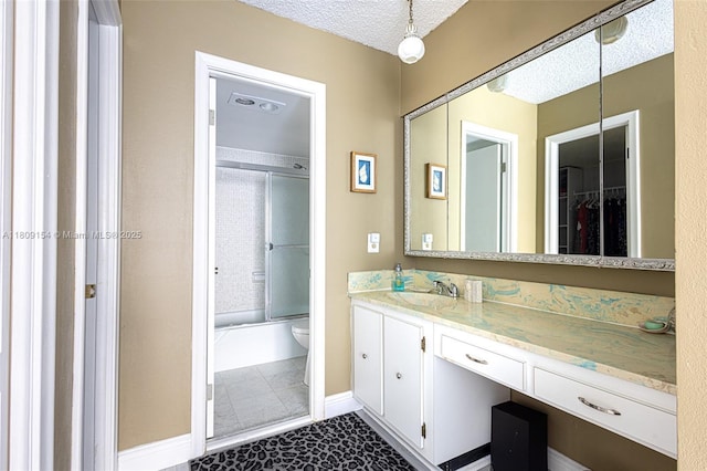 2000 S Ocean Blvd Unit 3B, Lauderdale By The Sea, FL 33062 - bathroom featuring vanity, shower / bath combination with glass door, toilet, a textured ceiling, and baseboards