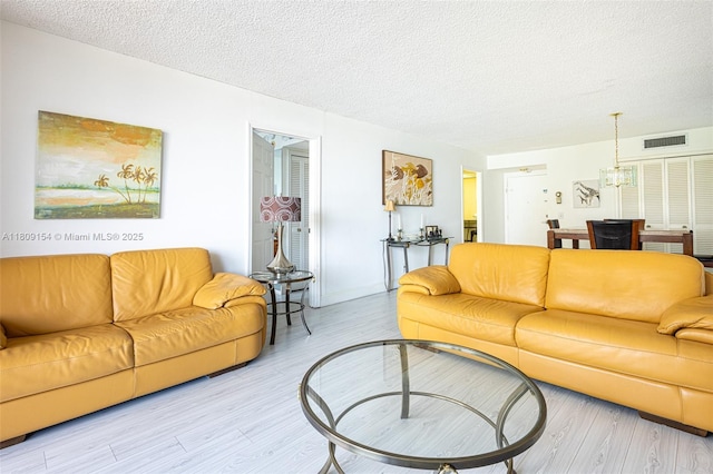 2000 S Ocean Blvd Unit 3B, Lauderdale By The Sea, FL 33062 - living area with a textured ceiling and light wood-style flooring