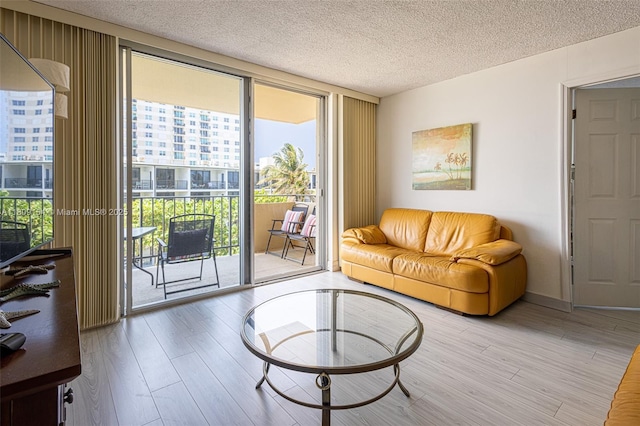 2000 S Ocean Blvd Unit 3B, Lauderdale By The Sea, FL 33062 - living room with wood finished floors, a textured ceiling, and expansive windows