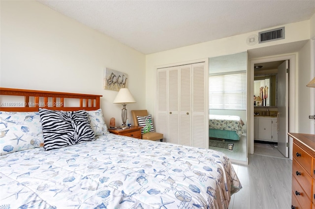 2000 S Ocean Blvd Unit 3B, Lauderdale By The Sea, FL 33062 - bedroom featuring light wood-style flooring, a closet, and ensuite bathroom