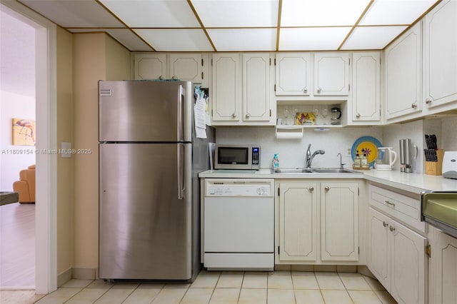 2000 S Ocean Blvd Unit 3B, Lauderdale By The Sea, FL 33062 - kitchen with appliances with stainless steel finishes, a paneled ceiling, light countertops, a sink, and light tile patterned floors