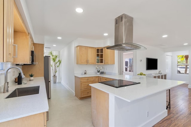 5492 Barnstead Cir, Lake Worth, FL 33463 - kitchen with island range hood, a sink, black electric cooktop, a breakfast bar area, and glass insert cabinets