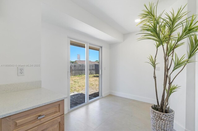 5492 Barnstead Cir, Lake Worth, FL 33463 - unfurnished dining area featuring baseboards