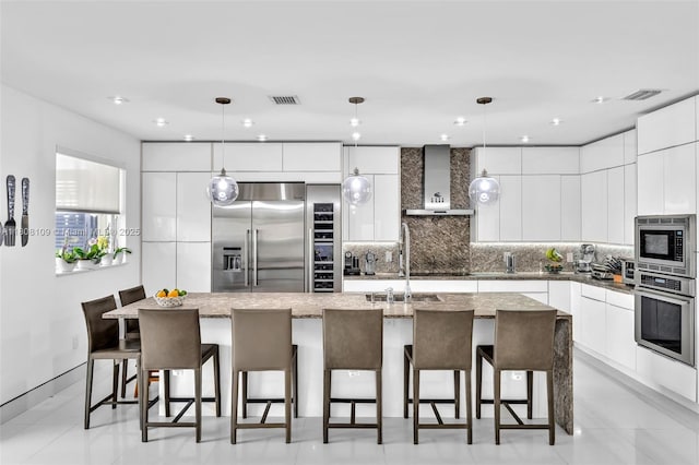 4362 NW 112th Ct, Doral, FL 33178 - kitchen featuring modern cabinets, built in appliances, wall chimney exhaust hood, tasteful backsplash, and recessed lighting