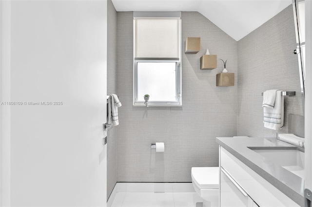 4362 NW 112th Ct, Doral, FL 33178 - half bath featuring toilet, vanity, vaulted ceiling, and tile patterned flooring