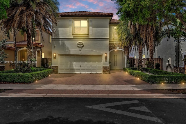 4362 NW 112th Ct, Doral, FL 33178 - mediterranean / spanish house with a tile roof, stucco siding, an attached garage, and decorative driveway