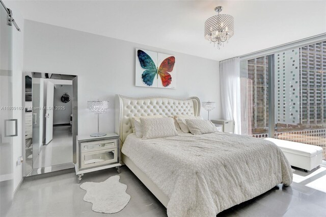 68 SE 6th St Unit 1203, Miami, FL 33131 - bedroom featuring a chandelier and a barn door
