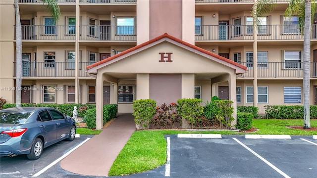 1100 SW 130th Ave Unit 111H, Pembroke Pines, FL 33027 - view of property featuring uncovered parking