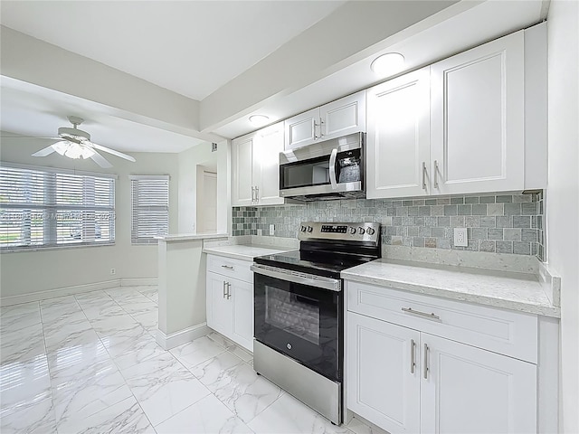 1100 SW 130th Ave Unit 111H, Pembroke Pines, FL 33027 - kitchen featuring stainless steel appliances, light marble finish flooring, decorative backsplash, white cabinetry, and a ceiling fan