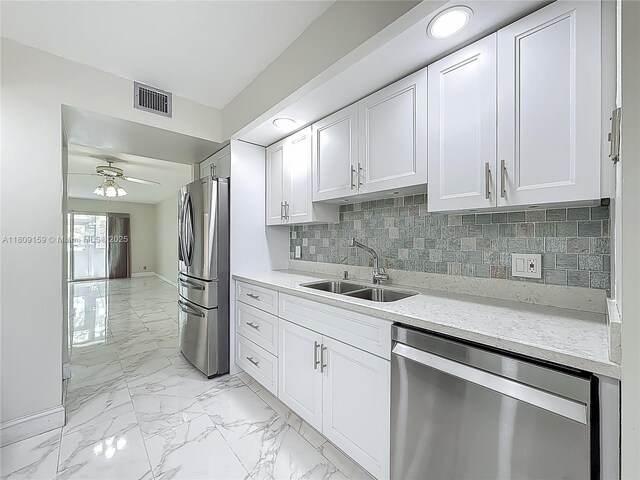1100 SW 130th Ave Unit 111H, Pembroke Pines, FL 33027 - kitchen with stainless steel appliances, a sink, white cabinets, ceiling fan, and light marble finish flooring