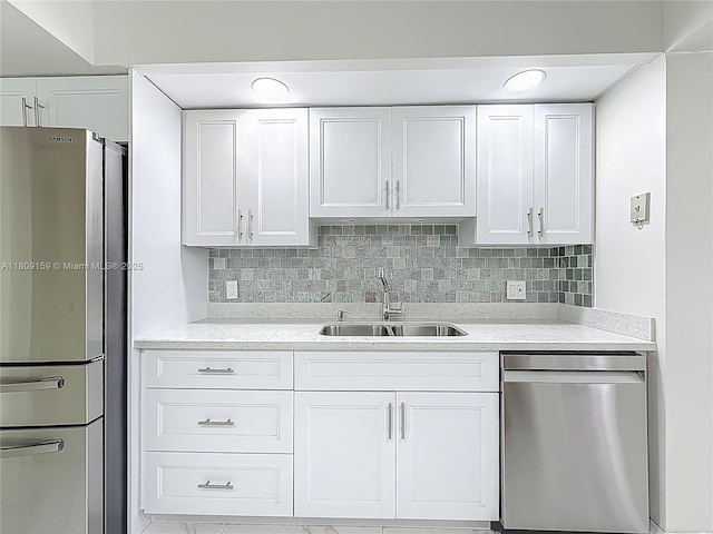 1100 SW 130th Ave Unit 111H, Pembroke Pines, FL 33027 - kitchen with stainless steel appliances, a sink, white cabinets, and decorative backsplash