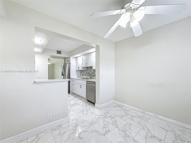 1100 SW 130th Ave Unit 111H, Pembroke Pines, FL 33027 - kitchen with appliances with stainless steel finishes, a ceiling fan, light marble finish floors, baseboards, and light countertops