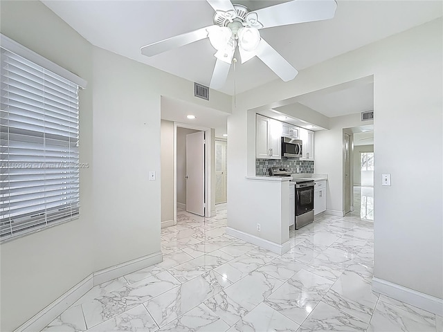 1100 SW 130th Ave Unit 111H, Pembroke Pines, FL 33027 - kitchen featuring electric stove, stainless steel microwave, light marble finish floors, and baseboards