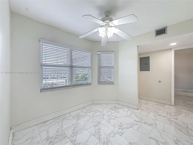 1100 SW 130th Ave Unit 111H, Pembroke Pines, FL 33027 - spare room featuring electric panel, light marble finish flooring, baseboards, and a ceiling fan