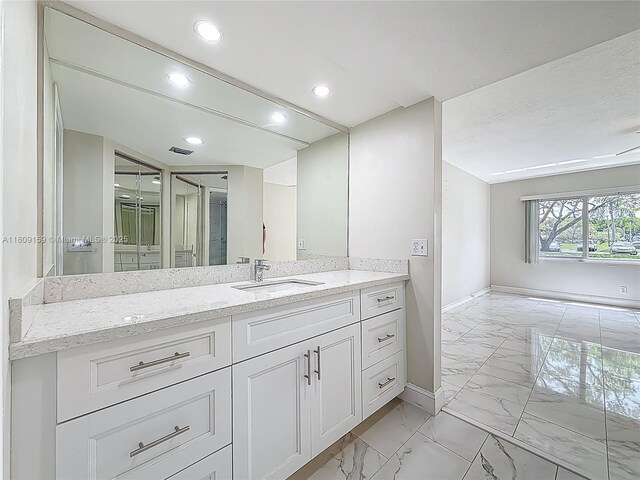 1100 SW 130th Ave Unit 111H, Pembroke Pines, FL 33027 - bathroom with marble finish flooring, baseboards, vanity, and recessed lighting