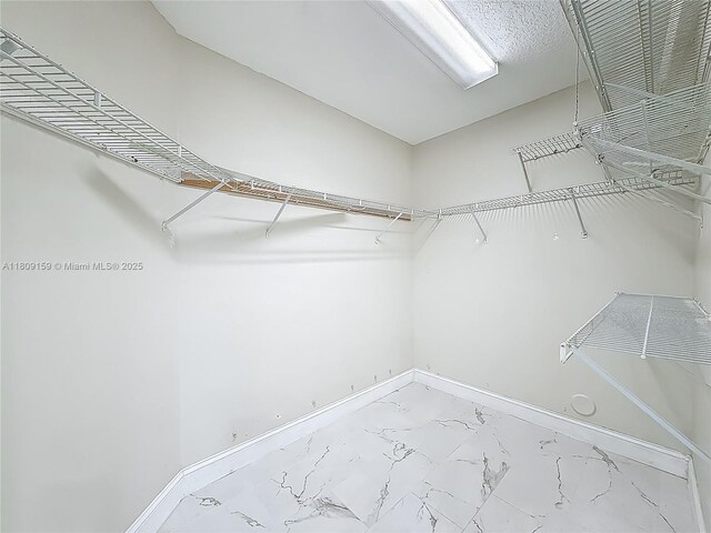 1100 SW 130th Ave Unit 111H, Pembroke Pines, FL 33027 - spacious closet featuring marble look tile flooring