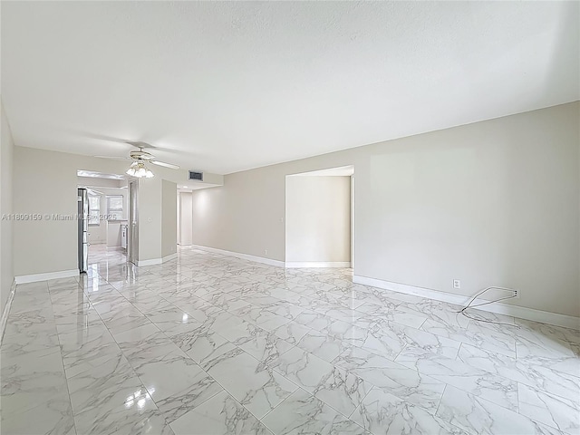 1100 SW 130th Ave Unit 111H, Pembroke Pines, FL 33027 - spare room featuring baseboards, light marble finish floors, and a ceiling fan