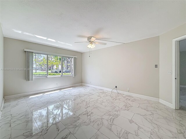 1100 SW 130th Ave Unit 111H, Pembroke Pines, FL 33027 - empty room with a ceiling fan, baseboards, and light marble finish flooring