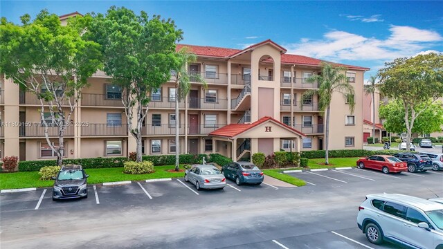 1100 SW 130th Ave Unit 111H, Pembroke Pines, FL 33027 - view of apartment building / complex featuring uncovered parking