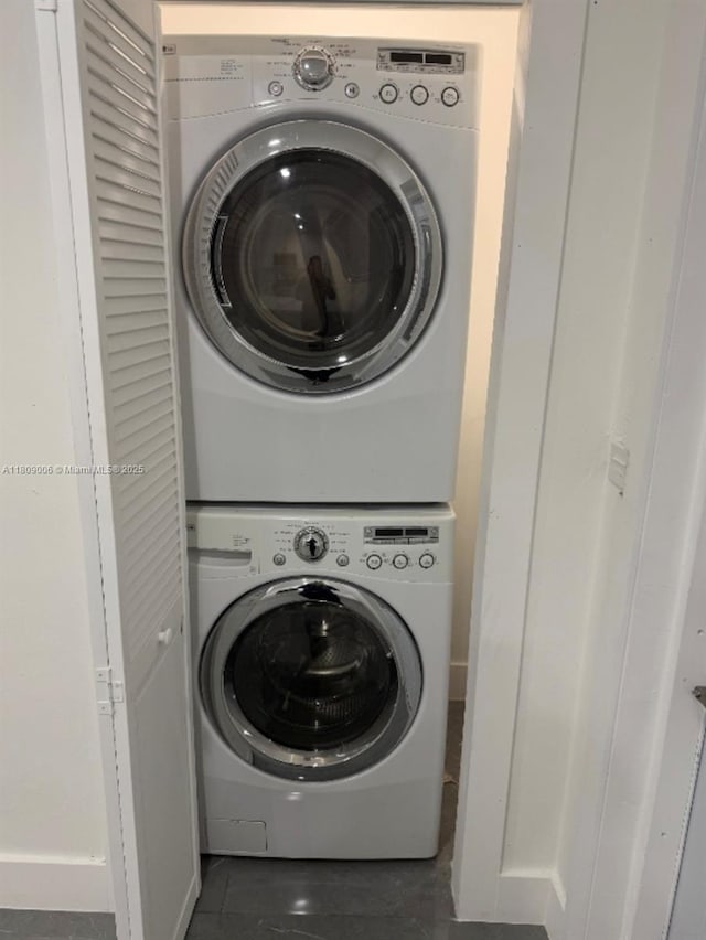 12455 SW 187th Ter, Miami, FL 33177 - washroom with estacked washer and dryer and dark tile patterned flooring