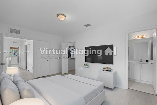 8206 SW 29th St Unit 104, Miramar, FL 33025 - bedroom featuring light wood-style floors, ensuite bath, and baseboards