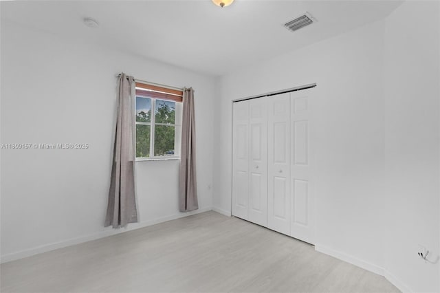8206 SW 29th St Unit 104, Miramar, FL 33025 - unfurnished bedroom with light wood-style flooring, baseboards, and a closet