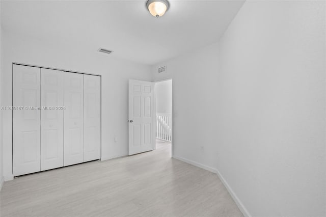 8206 SW 29th St Unit 104, Miramar, FL 33025 - unfurnished bedroom featuring baseboards, light wood-type flooring, and a closet